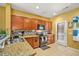 Well-lit kitchen featuring wooden cabinets, granite countertops, tile flooring and modern appliances at 9759 Seed St, Ladson, SC 29456