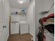 Clean laundry room with washer, dryer, and storage shelves at 9759 Seed St, Ladson, SC 29456