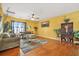 Comfortable living room with hardwood floors, a ceiling fan and lots of natural light at 9759 Seed St, Ladson, SC 29456