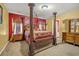 Elegant main bedroom with a four-poster bed, rich colors, and a warm, inviting atmosphere at 9759 Seed St, Ladson, SC 29456