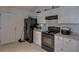 Functional kitchen features essential appliances, ample cabinet space, and neutral tiling at 101 Old Tree Rd, Goose Creek, SC 29445