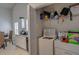 Convenient laundry area with washer, dryer, and shelving for storage located off the kitchen at 101 Old Tree Rd, Goose Creek, SC 29445
