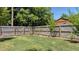 Large grassy backyard, enclosed by a tall wooden fence, and mature trees at 1010 Black Oak Rd, Bonneau, SC 29431