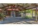 Covered patio and backyard with a ceiling fan, next to a lush, grassy yard at 1010 Black Oak Rd, Bonneau, SC 29431