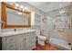 Bathroom featuring tiled walk-in shower, marble vanity and wood look tile flooring at 1010 Black Oak Rd, Bonneau, SC 29431