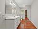 Bathroom featuring gray walls, wood floors, and long white vanity with mirror at 1010 Black Oak Rd, Bonneau, SC 29431