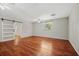 Bedroom featuring wood floors, light gray walls, ceiling fans, and sliding barn door to en suite at 1010 Black Oak Rd, Bonneau, SC 29431