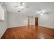 Bright bedroom with wood floors, gray walls, and open view to hallway at 1010 Black Oak Rd, Bonneau, SC 29431