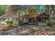 Exterior view of charming home with a covered area, and mature landscaping at 1010 Black Oak Rd, Bonneau, SC 29431