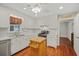 Bright kitchen features a ceiling fan, wood floors, an island and classic white cabinets at 1010 Black Oak Rd, Bonneau, SC 29431