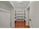 Walk-in closet with wood floors and white shelving at 1010 Black Oak Rd, Bonneau, SC 29431