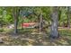 Large, partially shaded yard with mature trees, and shed in the background at 1010 Black Oak Rd, Bonneau, SC 29431