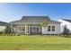 Expansive backyard showcasing a screened-in porch, lush lawn, and mature landscaping at 1021 Sagegrass Street, Summerville, SC 29485