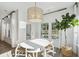 Bright dining room with modern chandelier, natural light, and views of the outdoor scenery at 1021 Sagegrass Street, Summerville, SC 29485