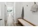 Inviting entryway with coat hooks, bench seating, and a view into the dining area at 1021 Sagegrass Street, Summerville, SC 29485