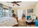 Bedroom featuring neutral walls, a wood floor, a patterned rug, a ceiling fan, and view to connected room at 1116 Daffodil Ln, Mount Pleasant, SC 29464