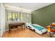 A bedroom features green walls, a car-shaped bed, desk by the window, and hardwood floors at 1116 Daffodil Ln, Mount Pleasant, SC 29464