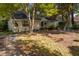 Quaint single-story home features a cozy front yard with mature trees providing ample shade at 1116 Daffodil Ln, Mount Pleasant, SC 29464