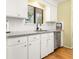 Well-lit kitchen features granite countertops, white cabinets, and stainless steel appliances at 1116 Daffodil Ln, Mount Pleasant, SC 29464