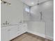 Bathroom featuring double sinks, white cabinets, and a tiled shower area at 1159 Reserve Ln, Awendaw, SC 29429