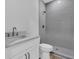 Bathroom with white cabinets, gray tile shower, and modern fixtures at 1159 Reserve Ln, Awendaw, SC 29429