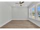 Bright bedroom with hardwood floors, fresh paint, ceiling fan, recessed lights, and ample windows at 1159 Reserve Ln, Awendaw, SC 29429