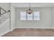 Bright dining room with hardwood floors and an elegant chandelier hanging from the ceiling at 1159 Reserve Ln, Awendaw, SC 29429