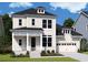 Charming two-story home with a well-manicured lawn, attached garage, and classic architectural details at 1159 Reserve Ln, Awendaw, SC 29429
