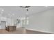 Bright living room with hardwood floors, white walls, recessed lights, and an open concept kitchen at 1159 Reserve Ln, Awendaw, SC 29429