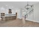 Spacious living area with hardwood floors, white walls, lots of natural light, and a statement chandelier at 1159 Reserve Ln, Awendaw, SC 29429