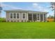 Enjoy this home's spacious backyard with lush green grass and screened-in porch, perfect for relaxing and entertaining at 1212 Reserve Ln, Awendaw, SC 29429