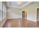 Spacious bedroom with hardwood floors, tray ceiling, and natural light from the windows at 1212 Reserve Ln, Awendaw, SC 29429