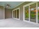 Covered outdoor patio with ceiling fan and sliding glass doors leading inside at 1212 Reserve Ln, Awendaw, SC 29429