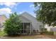 A backyard featuring a screened porch with surrounding trees and shrubs at 1216 Wild Goose Trl, Summerville, SC 29483
