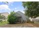 A backyard showcasing a screened porch surrounded by lush greenery at 1216 Wild Goose Trl, Summerville, SC 29483