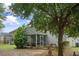 Backyard showcasing a screened porch and mature trees and bushes at 1216 Wild Goose Trl, Summerville, SC 29483