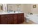 Bathroom featuring double sinks, a walk-in shower, and a luxurious soaking tub at 1216 Wild Goose Trl, Summerville, SC 29483