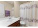 Clean bathroom features a cherry wood vanity, chrome fixtures, and a patterned shower curtain at 1216 Wild Goose Trl, Summerville, SC 29483