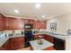 Modern kitchen featuring stainless steel appliances, granite countertops and dark wood cabinetry at 1216 Wild Goose Trl, Summerville, SC 29483