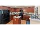 Modern kitchen featuring stainless steel appliances, granite countertops and dark wood cabinetry at 1216 Wild Goose Trl, Summerville, SC 29483