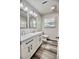 The updated bathroom features a double sink vanity with modern fixtures and hardwood floors at 1232 Hawthorne Cir, Hanahan, SC 29410