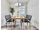 Charming dining room featuring a wooden table, stylish black chairs, and a decorative chandelier at 1232 Hawthorne Cir, Hanahan, SC 29410