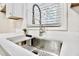 Close up of stainless steel kitchen sink with modern faucet and quartz countertops at 1232 Hawthorne Cir, Hanahan, SC 29410