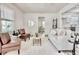 Stylishly furnished living room boasts an open layout, wood-look floors, and lots of natural light at 1232 Hawthorne Cir, Hanahan, SC 29410