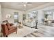Bright and airy living room seamlessly connects to dining and kitchen, with stylish decor and wood-look flooring at 1232 Hawthorne Cir, Hanahan, SC 29410