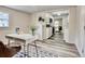 Modern office space with white desk, decor, with view into a bright, updated kitchen and living area at 1232 Hawthorne Cir, Hanahan, SC 29410