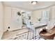 Cozy office space with modern desk, decor, and view into a bright, updated kitchen with white cabinets at 1232 Hawthorne Cir, Hanahan, SC 29410