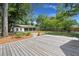 Spacious backyard with a deck, a three-car garage, and a fire pit for outdoor gatherings at 1260 Old Whitesville Rd, Moncks Corner, SC 29461