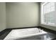 Bright bathroom with a luxurious soaking tub beneath a large window, perfect for relaxation at 1260 Old Whitesville Rd, Moncks Corner, SC 29461