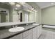 Well-lit bathroom featuring double sinks, a large mirror, and a tub at 1260 Old Whitesville Rd, Moncks Corner, SC 29461